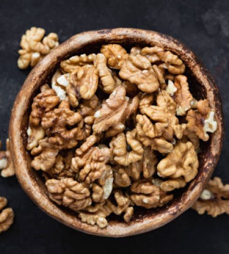 Walnuts in bowl top view. Selective focus